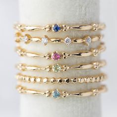 This dainty birthstone stackable ring is unlike any other, the band has a unique design all around which gives a bit of antique feel. Perfect gift for July birthdays! * Stock size: US 7 * Genuine 1.5mm blue sapphire * Band width: ≈1.75mm * Setting size: ≈2mm * Material: 14k solid yellow gold (rose gold or white gold option available) * Made of 100% recycled precious metal and ethically sourced gemstone * Comes in a gift box with a bow ready for gifting * Handmade with love and great care in New Dainty Diamond Stackable Rings With Birthstone, Dainty Diamond Birthstone Stackable Rings, Dainty Sapphire Ring With Diamond, Gold Stackable Rings With Sapphire Bezel Setting, Gold Sapphire Stackable Rings With Bezel Setting, Everyday Gold Stackable Sapphire Ring, Dainty Sapphire Diamond Ring, Sapphire Birthstone Dainty Ring, Yellow Gold Sapphire Stackable Rings With Bezel Setting