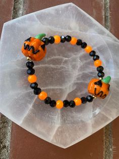 Spooky season is here and this beautiful bracelet is perfect to show off your spooky spirit Handmade Adjustable Jewelry For Halloween, Halloween Gift Bracelets With Round Beads, Halloween Gift Stretch Bracelet With Round Beads, Halloween Gift Jewelry With Round Beads, Beaded Bracelets For Halloween Gift, Halloween Gift Stretch Bracelet, Halloween Black Beaded Jewelry, Adjustable Black Beaded Bracelets For Halloween, Handmade Stretch Bracelet For Halloween