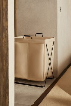 a large white box sitting on top of a floor next to a mirror and door