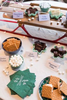 S'mores bar set up, tags, and green "Oui Oui Apres Ski" napkins. All you need to throw a bachelorette party in one box! Cups, napkins, plates, koozies, tank tops, banners, balloons, personalized invitations and schedules, s'mores bar signage, door sign, and beanies. Bachelorette Party Themes For Winter, Winter Chic Bachelorette, Vermont Bachelorette Party, Aspen Bachelorette Party, Gatlinburg Bachelorette Party, Cozy Bachelorette Party, Cabin Bachelorette Party Ideas, Lake House Bachelorette Party, Gatlinburg Bachelorette