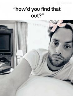 a man laying on top of a bed next to a tv