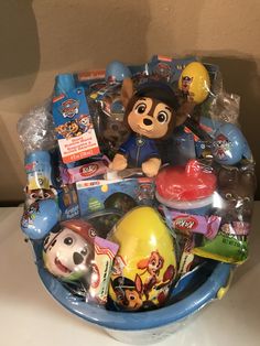 a blue bowl filled with lots of toys