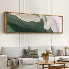 a living room with a couch, coffee table and painting on the wall above it