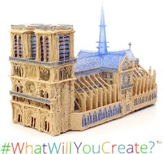 a wooden model of a cathedral with a blue roof and steeple on the top