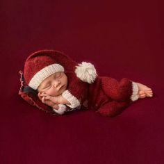 a newborn baby wearing a red and white hat