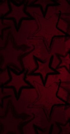 an abstract red background with black stars