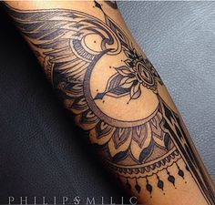 a tattoo on the leg of a person with an eagle and sun in the background