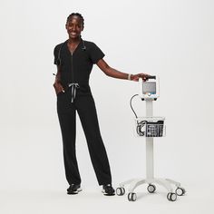 Official FIGS® Scrubs. Ridiculously Soft Scrubs Designed Just For You. Get Free Shipping On Orders $50+! | FIGS Womens Black Catarina™ ScrubJumpsuit™ Black Scrubs Outfit, Hospital Photoshoot, Black Figs, Vest Layering, Nursing Scrubs, Black Fig, Scrubs Outfit, Black Scrubs, Easy Dress