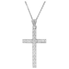 17 round brilliant cut diamond cross pendant necklace in 14k white gold on a 18 inch 14k white gold chain. 17 round brilliant cut diamonds, .45cts 14k white gold Stamped: 14KT 6.0 grams Top to bottom: 34.9mm or 1 1/3 Inch Width: 17mm or 5/8 Inch Depth of thickness: 2.1mm Chain: 18 Inches White Gold Diamond Cross Pendant Necklace With Pavé Setting, Classic White Diamond Cross Pendant Necklace, White Gold Diamond Round Cross Necklace, White Gold Round Diamond Cut Cross Necklace, Formal White Diamond Cut Cross Necklace, Formal White Gold Crucifix Diamond Necklace, Classic Diamond Cut Cross Necklace In White Gold, White Gold Crucifix Diamond Necklace For Anniversary, White Gold Diamond Crucifix Necklace