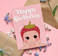 a birthday card with an image of a baby wearing a strawberry hat on top of it