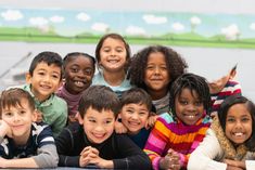 a group of young children posing for a photo together stock photo and more pictures from this time of the day