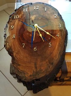 a clock that is on top of a piece of wood in the middle of a floor