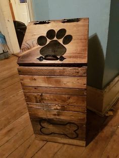 a wooden box with a dog's paw painted on the top and bottom part