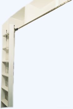 a mirror that is hanging on the side of a wall with shelving units in front of it