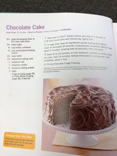 an open book with chocolate cake on it's cover and instructions to frosting the cake