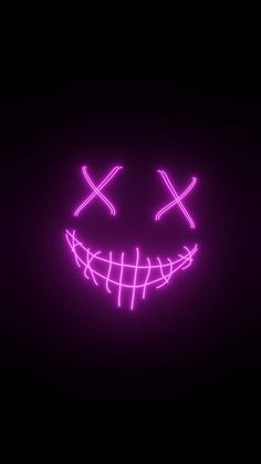 a neon mask with two crosses on it's face in the dark, lit up