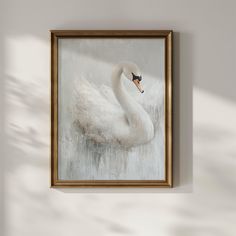 a painting of a white swan is hanging on the wall