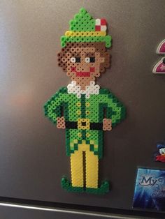 an image of a man made out of perler beads on the side of a refrigerator