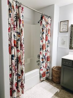 a bathroom with a bathtub, shower curtain and rug