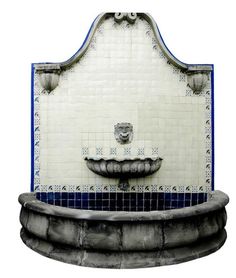 an artistic fountain with blue and white tiles on the sides, in front of a white background