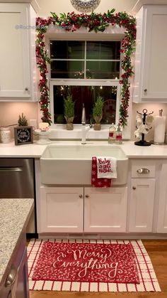 a kitchen decorated for christmas with red and white decor