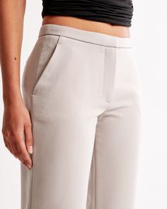 Elevate your wardrobe with the Abercrombie & Fitch Women's Low Rise Tailored Boot Pant in a sophisticated Ash color. These pants seamlessly blend comfort and style, making them a must-have for any fashion-forward wardrobe.

- Size: 34 REG
- Color: Ash
- Material: Polyester, Viscose, Elastane
- Gender: Female

Designed with a low rise and bootcut silhouette, these pants feature a slim waistband, functional pockets, and a smooth zipper closure. The tailored design and neutral hue ensure they pair Straight Work Bottoms With Hip Pockets, Modern Straight Fit Pants With Pockets, Modern Straight Fit Bottoms With Straight Hem, Modern Slim Fit Pants With Straight Hem, Sleek Pants With Pockets And Straight Hem, Straight Leg Pants With Seam Detailing For Business Casual, Fitted Pants With Seam Detailing And Straight Hem, Fitted Straight Work Pants For Spring, Modern Fitted Straight Bottoms