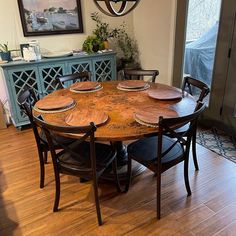 a dining room table with chairs and plates on it