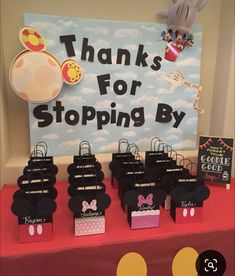 a table with mickey mouse bags on it and a sign that says thanks for stopping by