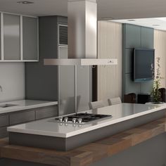 a modern kitchen with an island and stove top