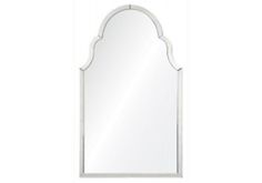 a white wall mirror with an arch shaped design on the top and bottom half of it