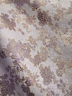 A beautiful, lilac and gold, floral brocade fabric. It is great for apparel, drapery, and much more. High quality. Sold by the yard. (1 yard= 36 in.) Width is 60 in. All orders will be cut in one continuous piece. Free shipping in US. For any large or wholesale orders, message us. Thank you for your time and business! Luxury Purple Embroidered Fabric Traditional Drape, Luxury Embroidered Fabric For Eid Reception, Luxury Purple Embroidered Fabric For Eid, Luxury Designer Wear Purple Embroidered Fabric, Luxury Festive Purple Embroidered Fabric, Luxury Purple Embroidered Fabric For Festive Season, Luxury Embroidered Purple Fabric For Designer Wear, Luxury Purple Embroidered Fabric With Zari Work, Luxury Wedding Fabric With Traditional Patterns