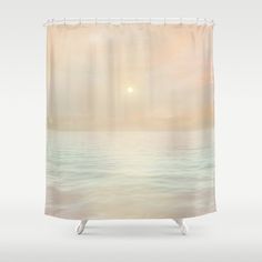 the sun is setting over the ocean shower curtain