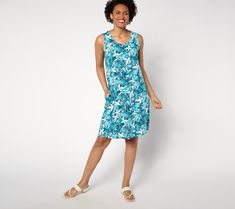 Vacay vibes and versatile style make this printed knee-length dress a perfect fit for picnics, summer celebrations, and even poolside. An effortless essential that goes everywhere in the warmer weather, it can be a beach coverup by day and a breezy dress for waterside dining in the evening -- just shake the sand off your feet and add a strappy sandal (we won't tell)! From Denim & Co.® Fashions. Casual Tropical Print Sundress For Summer Outings, Blue Casual Dress For Resort Season, Casual Blue Dress For Resort Season, Summer Tropical Print Sundress For Poolside, Casual Tropical Print Sundress For Beach, Casual Beach Sundress With Tropical Print, Summer Midi Dress For Poolside, Casual Printed Poolside Dresses, Summer Floral Print Sundress For Poolside