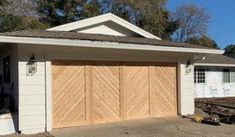 a garage with two wooden doors in front of it