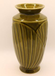 This is a vintage mid-century art-deco style ceramic pottery vase with scallop fans decorating the side.  It is unmarked and unbranded. The vase is approximately 7" tall and 4" in diameter. This used vintage item is in overall good condition.  The glaze has crazed from age and there is a black mark on the bottom from an old price handwritten in black marker. See the photos for the overall condition and detail of the item.  More photos can be sent upon request before purchase. Thank you for viewing my listing!  Be sure to check out the other books, antique, vintage, and collectible items I have for sale.  New items are listed every day. Shipping: Note that you can select either standard FedEx Ground (does not ship to P.O. Boxes) or expedited USPS Priority Mail.  International buyers select Mellow Autumn, Mid Century Modern Art Deco, Books Antique, Ceramic Pottery Vase, Mid Century Art Deco, Ceramics Pottery Vase, Green Pottery, Vintage Mid Century Modern, Modern Art Deco