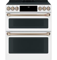 two white ovens side by side with gold knobs on the top and bottom