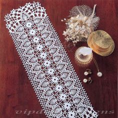 white crocheted doily on wooden table next to other accessories and flowers,