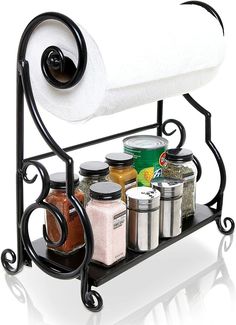 a towel rack with spices, salt and pepper shakers on the bottom is holding a roll of toilet paper