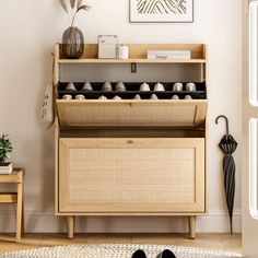 a wooden cabinet with shoes on it in a living room