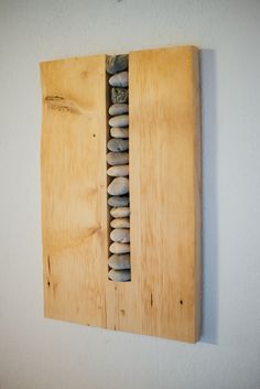 a piece of wood that has some rocks in it on the side of a wall