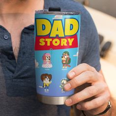 a man holding up a travel mug with the words dad story on it and cartoon characters