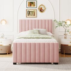 a bed with pink velvet upholstered headboard and foot board in a white bedroom