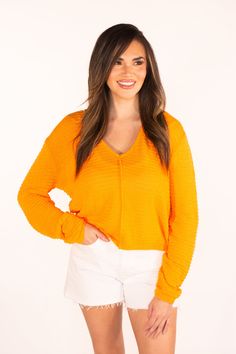 The Sweet Surprise Orange Light Weight Sweater has a bright and happy hue. With a relaxed fit and slightly sheer fabric, it's perfect to wear as we transition into spring. Just pair with a tank or bandeau underneath and you're ready to go. We recommend getting your true size Amanda is 5'3 and is wearing a size small Hand Wash Cold Hang to Dry 67% Polyester & 33% Cotton Apricot Lane Boutique, Orange Light, Resort Collection, Crop Top Blouse, Sheer Fabric, Small Hands, Light Orange, Sweater Blouse, Sheer Fabrics