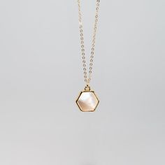 Hexagon shaped gemlets are electroplated in recycled brass with 24K gold overlay and hang delicately from a 14K gold filled 18" chain. 10mm Stone. Offered in a variety of stones that embrace and emit healing properties. Check out a stone encyclopedia here. Gold Octagon Birthstone Jewelry, Minimalist Gold Hexagon Necklace, Gold Elegant Charm Necklaces For Healing, Gold Crystal Necklace With Pearl Pendant For Gift, Minimalist Gold Hexagon Jewelry, Elegant Gold Hexagon Jewelry, Gold Hexagon Faceted Necklace, Hexagon 14k Gold Jewelry Gift, Hexagon Jewelry With Adjustable Chain For Gifts