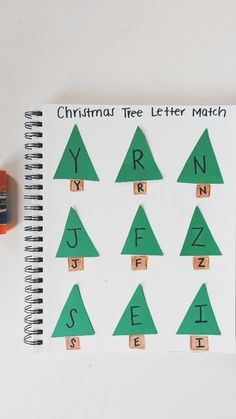 a christmas tree letter match is shown on a notepad