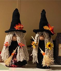 two crocheted witches sitting next to each other