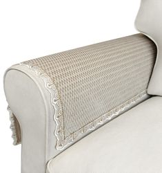 the back end of a white couch with scalloped trimmings on it