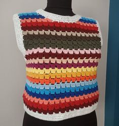 Multicolor Knit Crochet Top With Crochet Trim, Handmade Bohemian Knit Tops, Crochet Knit Top For Festivals, Multicolor Crochet Lace Knit Top, Multicolor Sleeveless Crochet Lace Top, Bohemian Sleeveless Crochet Knit Top, Bohemian Cotton Crochet Tank Top, Multicolor Crochet Lace Sleeveless Top, Bohemian Knitted Crop Top