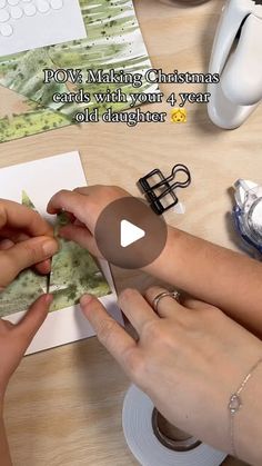 two women are making christmas cards with their hands