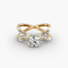 a yellow gold ring with an oval cut diamond in the center and side stones on each band